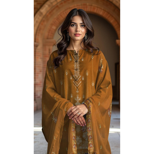 Woman wearing a mustard yellow embroidered traditional outfit in an indoor setting.