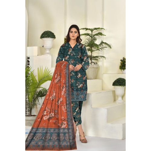 Woman wearing a floral dress with a matching dupatta in a decorated room.