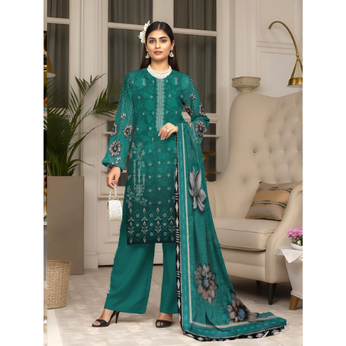 Woman wearing a teal embroidered outfit in a stylish room.