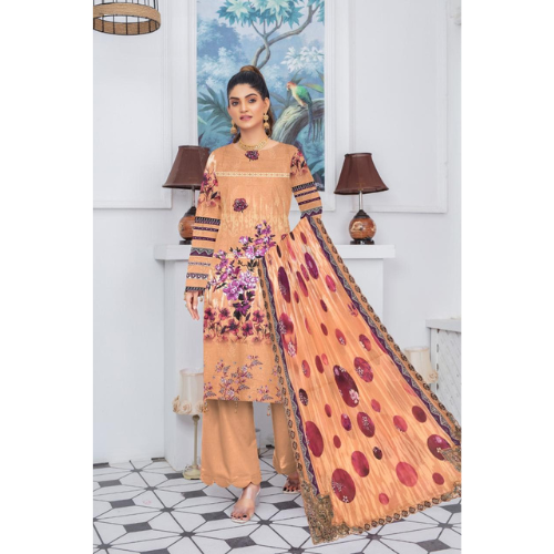Woman wearing a peach-colored traditional outfit with floral patterns in a decorated room.