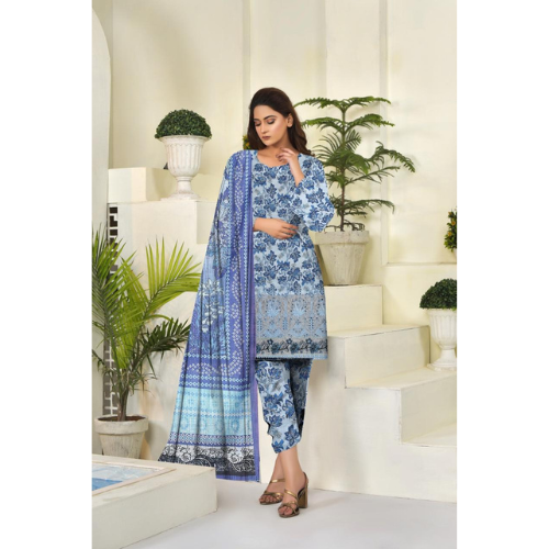 Woman wearing a blue and white patterned outfit in a decorated room with plants.