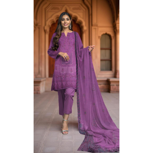 Woman wearing a purple traditional outfit with a matching dupatta in an indoor setting.