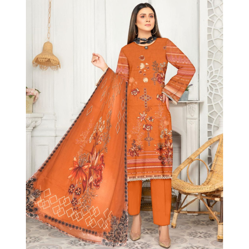Woman wearing an orange embroidered outfit with a matching dupatta in a decorated room.