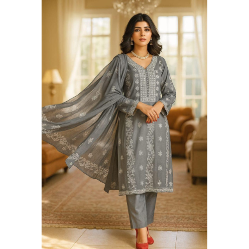 Woman wearing a gray embroidered outfit with a matching dupatta in a well-lit room.