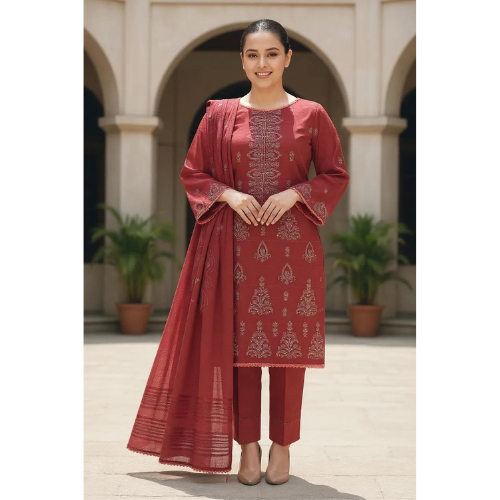 Woman wearing a red traditional outfit with intricate patterns in an outdoor setting.
