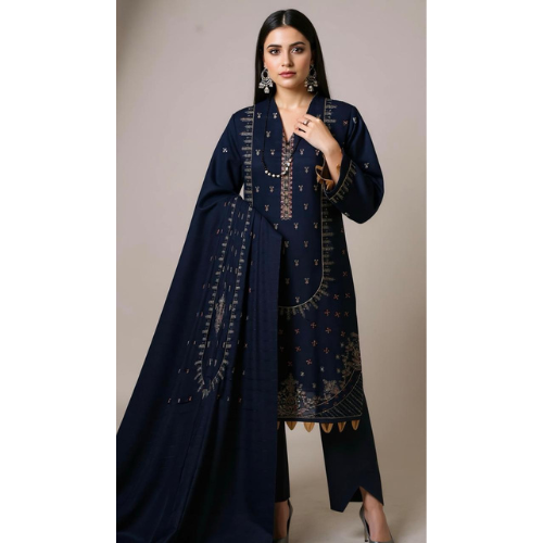Woman wearing a navy blue embroidered outfit with a plain background