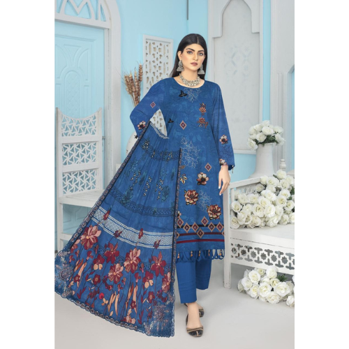 Woman wearing a blue embroidered traditional outfit in a decorated room.