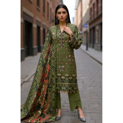 Woman wearing a green traditional outfit with a patterned dupatta on a city street.