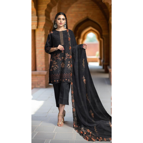 Woman in a black traditional outfit with floral patterns standing in an archway.