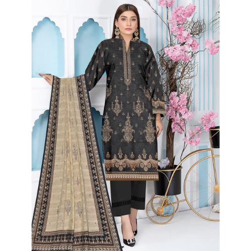 Woman wearing a black embroidered dress with a beige dupatta, standing next to decorative elements.