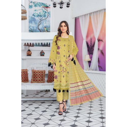 Woman wearing a yellow dress with floral patterns in a decorated room.