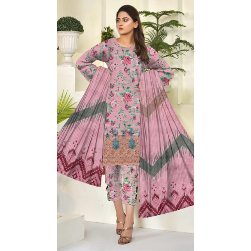 Woman wearing a pink floral dress with geometric patterns in a decorated indoor setting.
