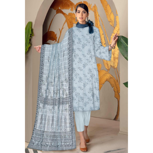 Woman wearing a light blue embroidered outfit with a matching dupatta in front of a decorative wall.